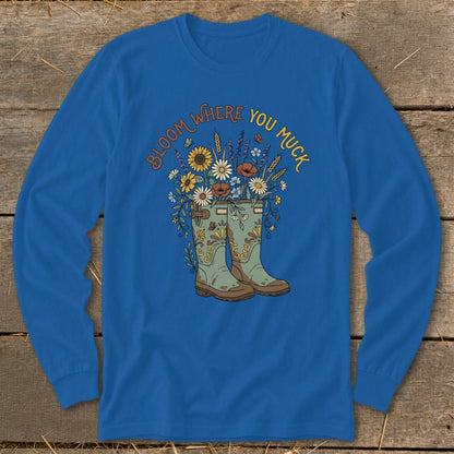 Blue long-sleeve shirt with boots and flowers graphic reading "Bloom Where You Muck."