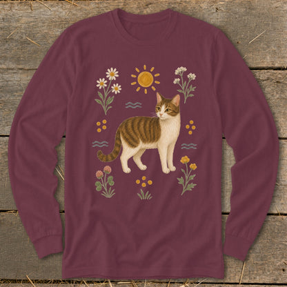 Long-sleeve maroon t-shirt with a tabby cat and floral sun graphic print.