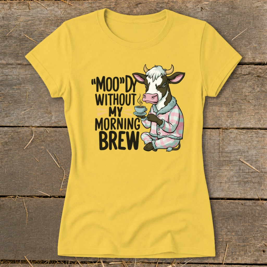 Yellow t-shirt with cow in pajamas holding coffee and text: "MOO"DY WITHOUT MY MORNING BREW.