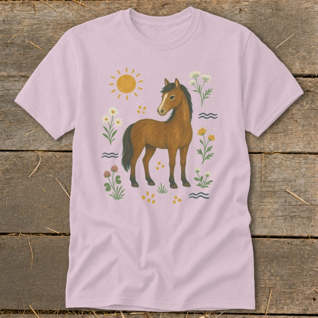 Light pink t-shirt with a brown horse, sun, flowers, and wavy lines graphic.