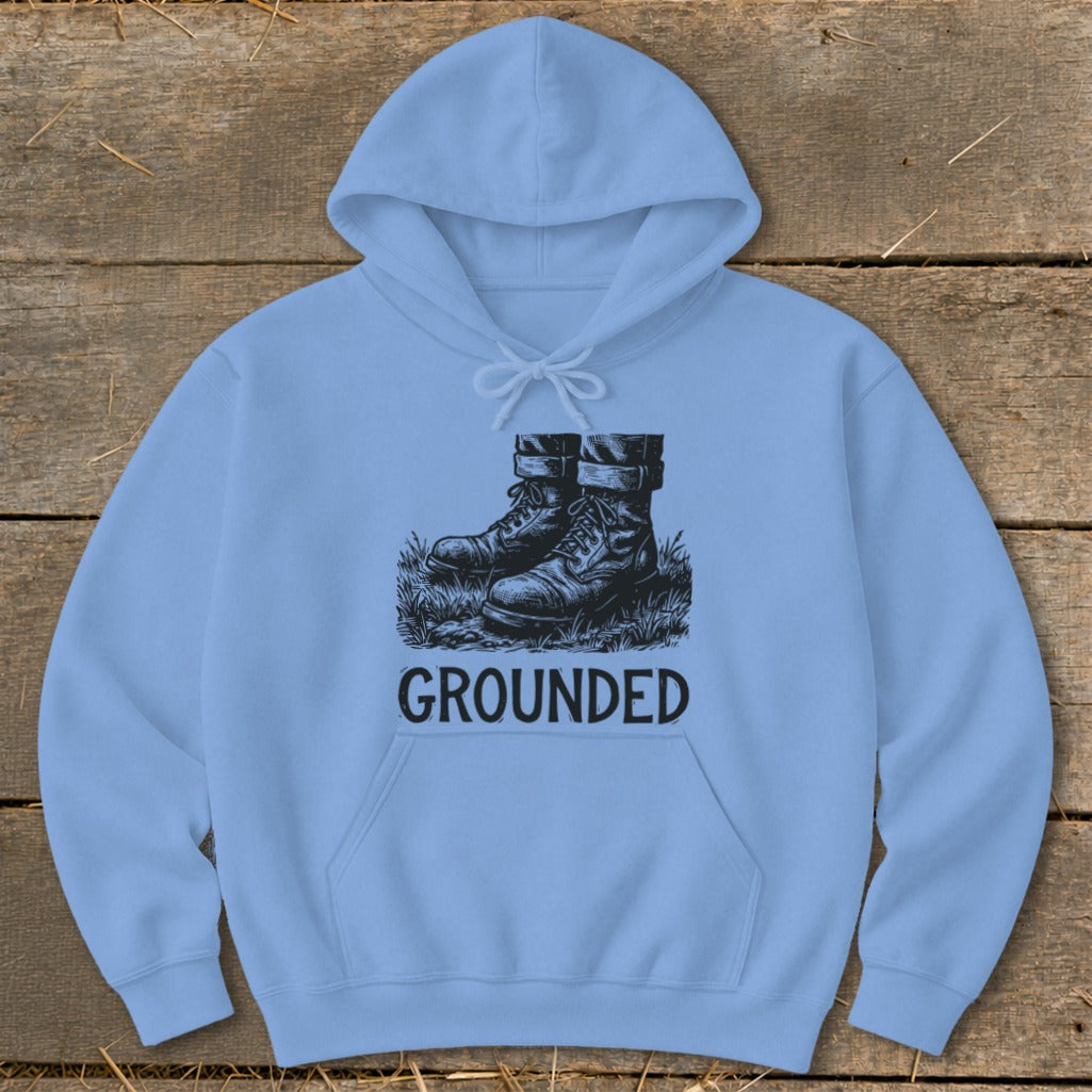 Light blue hoodie with a black graphic of boots in grass and the word GROUNDED.