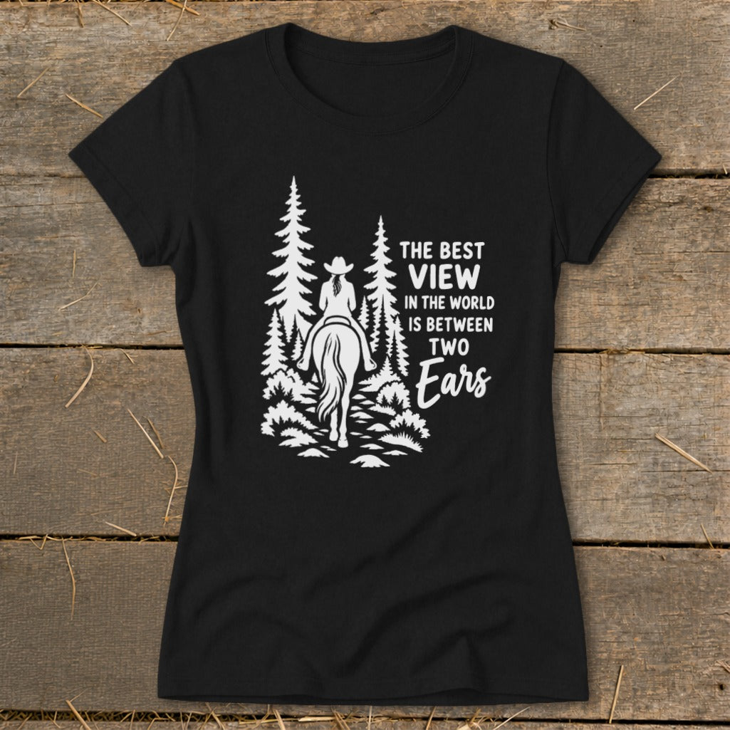 Black t-shirt featuring a white graphic of a horse rider in the woods and the text The Best View in the World is Between Two Ears.