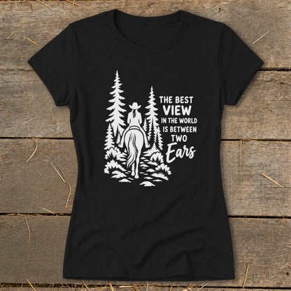 Black t-shirt featuring a white graphic of a horse rider in the woods and the text The Best View in the World is Between Two Ears.
