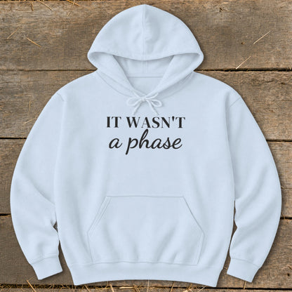Light blue hoodie with "IT WASN'T a phase" text and a kangaroo pocket.