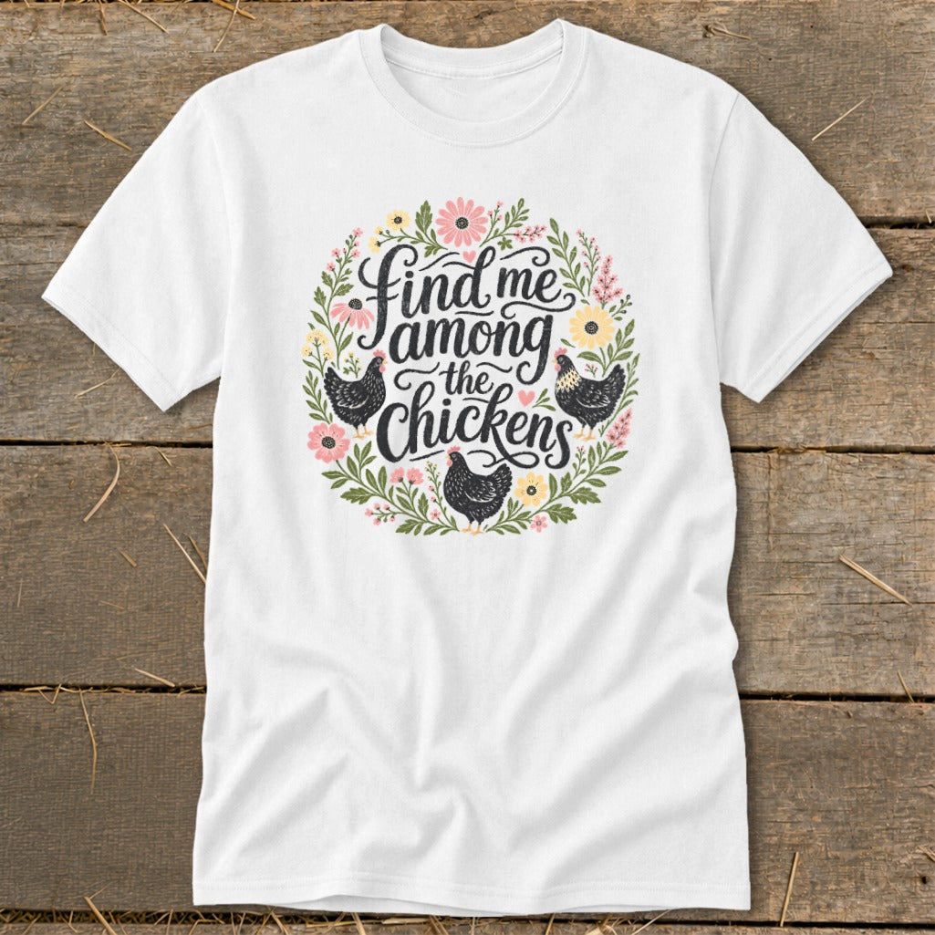 White t-shirt with floral wreath graphic and text "Find me among the chickens" with chickens.