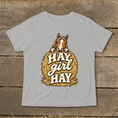 Gray t-shirt with illustration of horse on hay bale, text "Hay girl Hay".