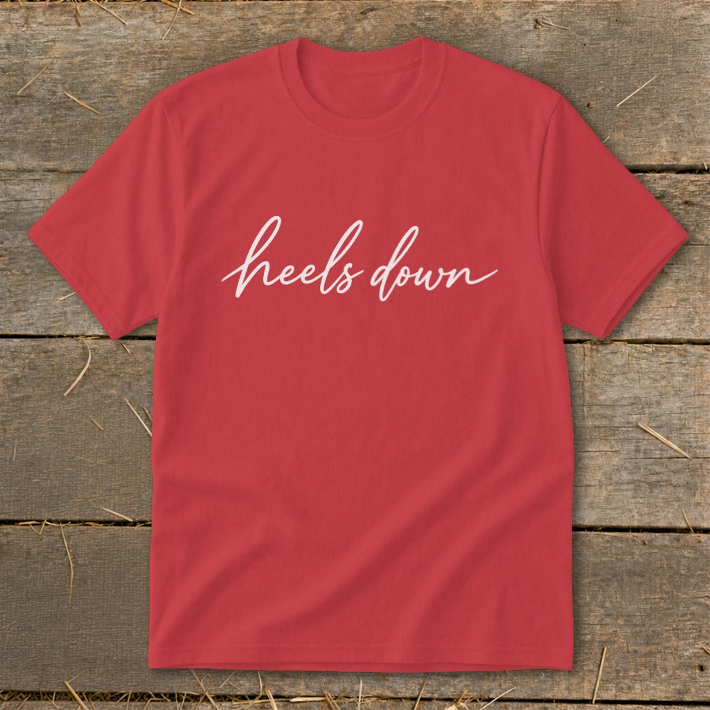 Red t-shirt with "heels down" in white cursive text.