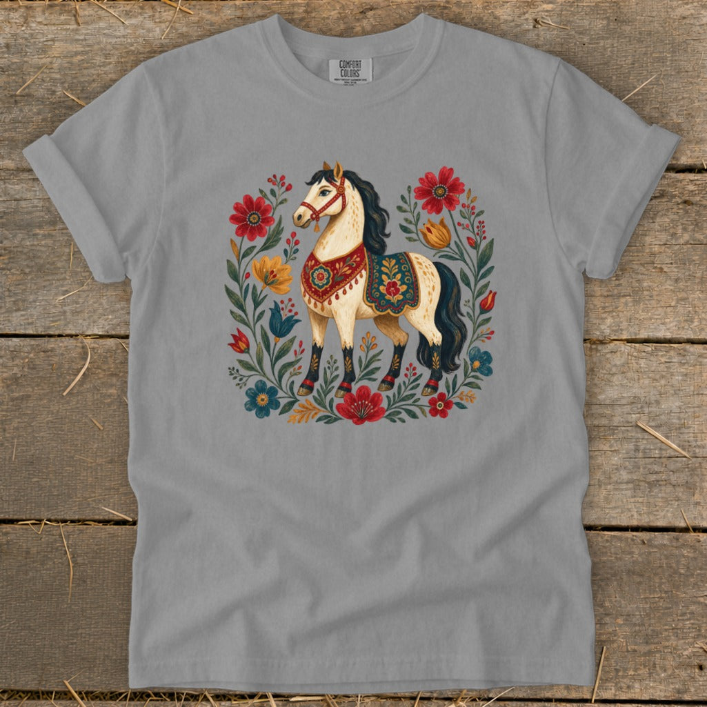 T-shirt with a cream-colored horse adorned in a floral, folk-art style design.