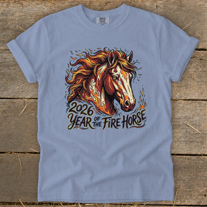 Light blue t-shirt with a graphic of a fiery horse and text "2026 Year of the Fire Horse".