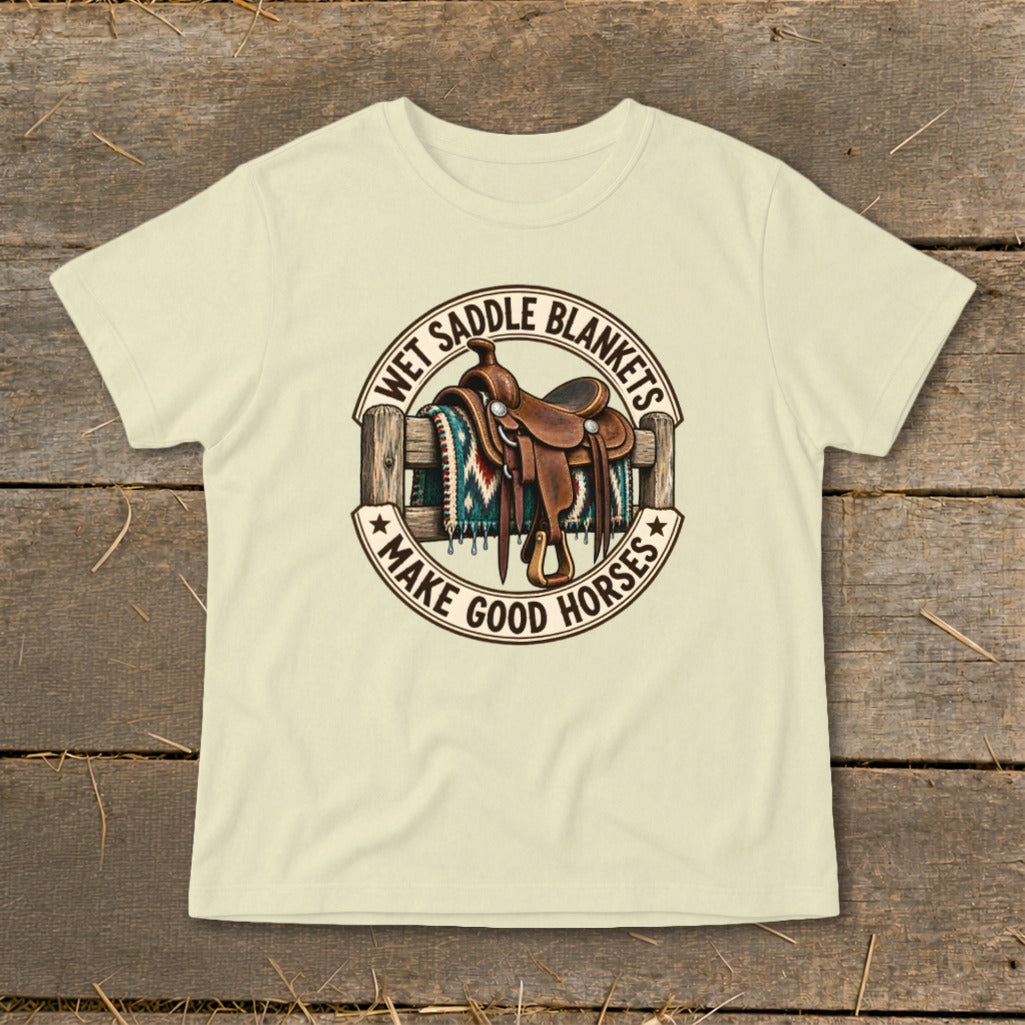 Graphic on cream t-shirt shows a saddle, blanket, and fence with text.