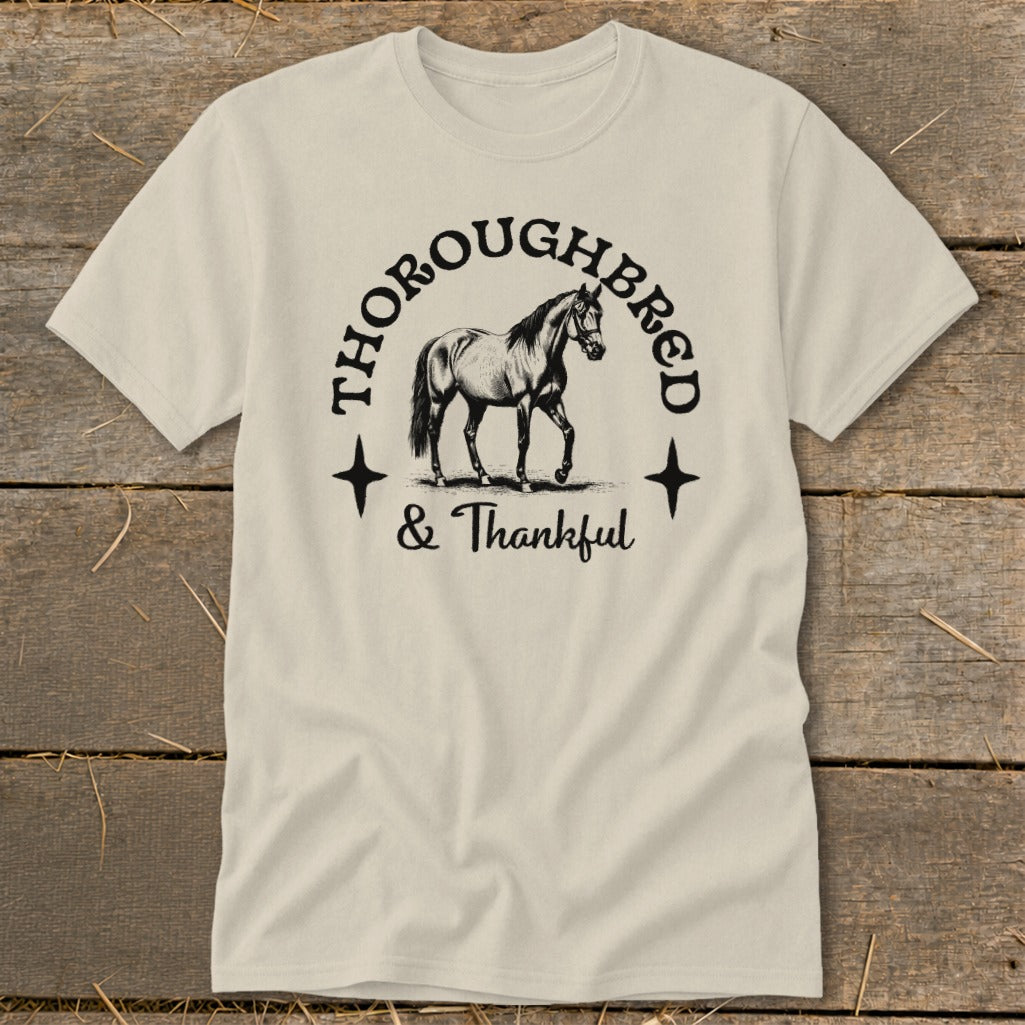 Thoroughbred & Thankful text with a drawing of a horse on a cream t-shirt.