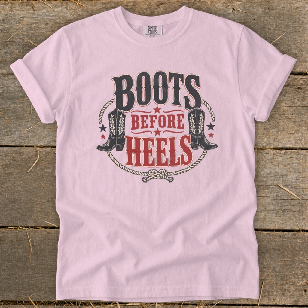 Pink t-shirt with "Boots Before Heels" graphic and cowboy boots.