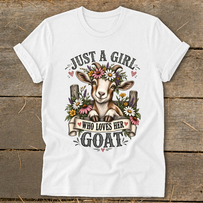 White t-shirt with a smiling goat wearing flowers and text that says "Just a girl who loves her goat."