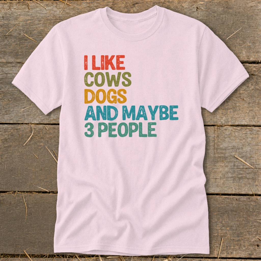 Pink t-shirt with "I like cows dogs and maybe 3 people" text.