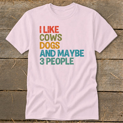 Pink t-shirt with "I like cows dogs and maybe 3 people" text.
