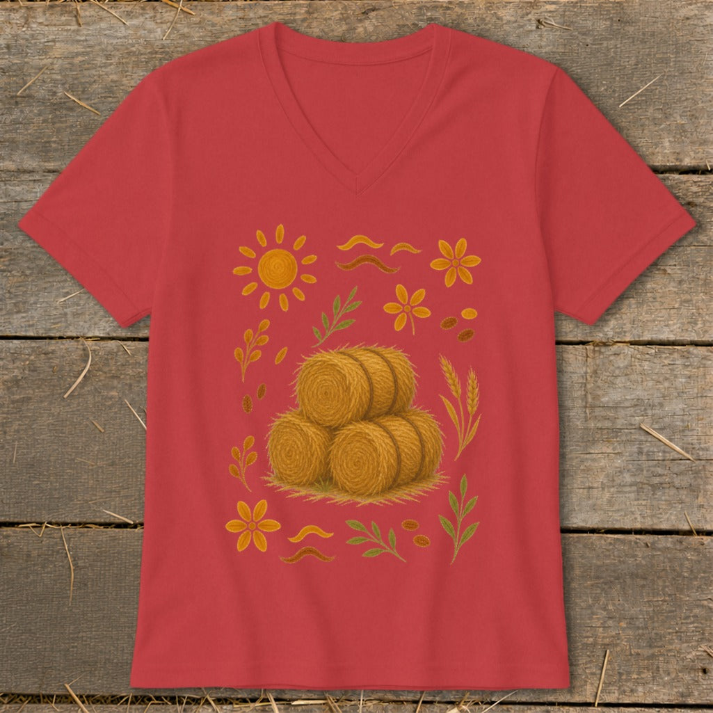 Red v-neck shirt with illustration of hay bales and autumn farm motifs.