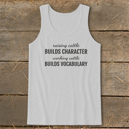 Light gray tank top with black text: "raising cattle BUILDS CHARACTER working cattle BUILDS VOCABULARY".