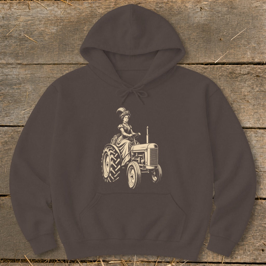 Brown hoodie with a vintage-style illustration of a woman in a Victorian dress driving a tractor.