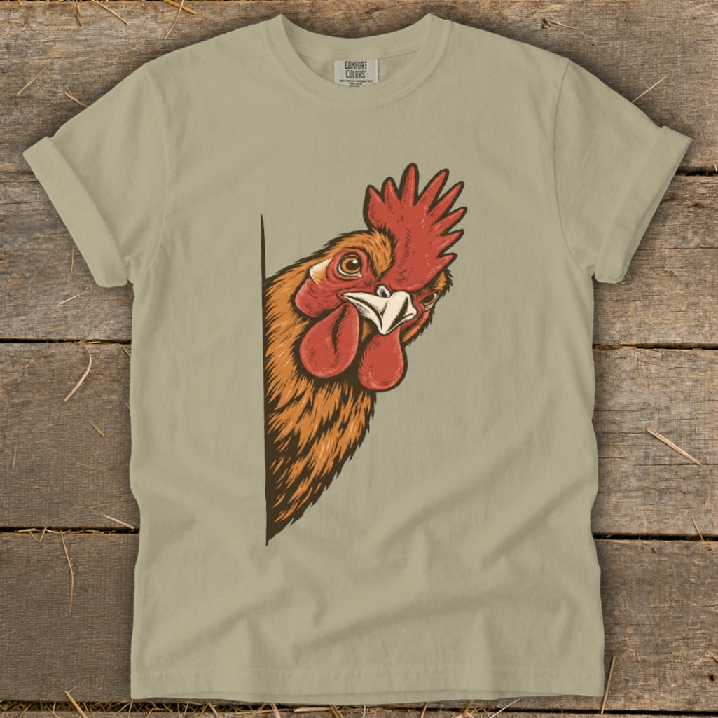 Tan t-shirt with a rooster's head peeking from the left edge.
