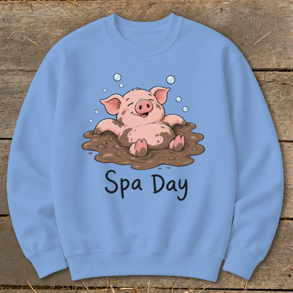 Light blue sweatshirt with a cartoon pig relaxing in mud, reading "Spa Day."