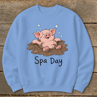 Light blue sweatshirt with a cartoon pig relaxing in mud, reading "Spa Day."
