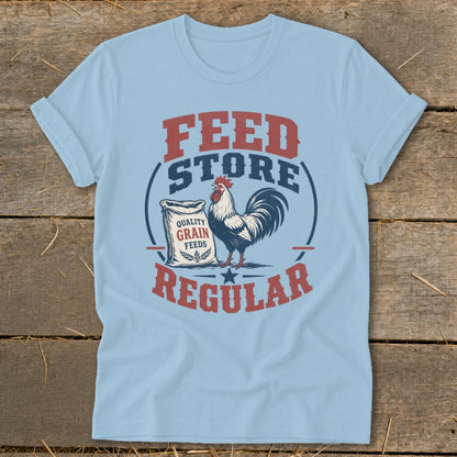 Light blue t-shirt with "Feed Store Regular" text, rooster, and grain bag graphic.