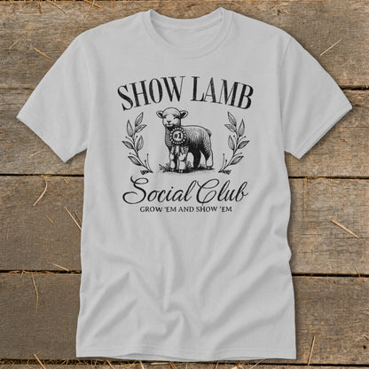Light gray t-shirt with "SHOW LAMB Social Club GROW 'EM AND SHOW 'EM" and a sheep.