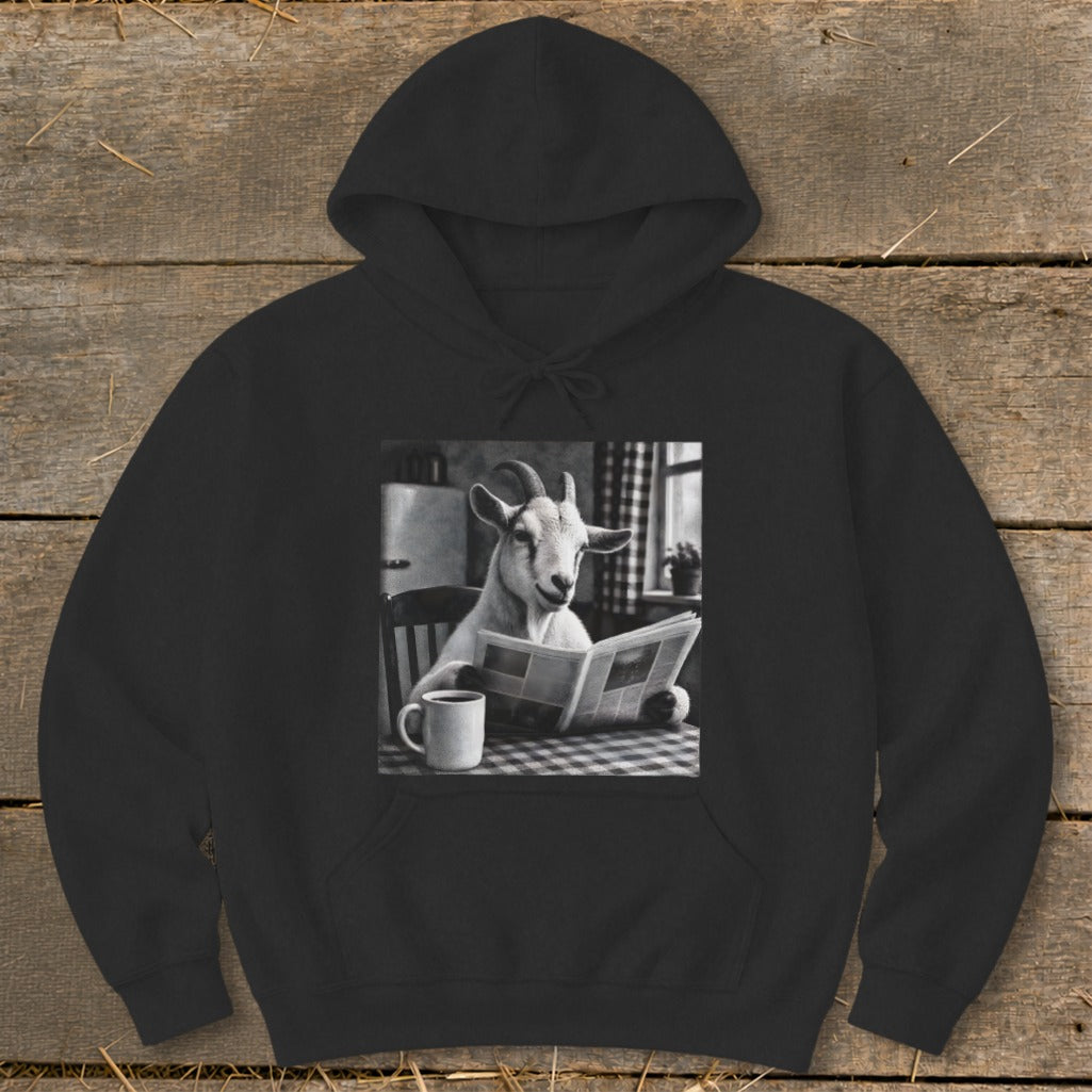 Black hooded sweatshirt featuring a graphic of a goat reading a newspaper at a kitchen table.