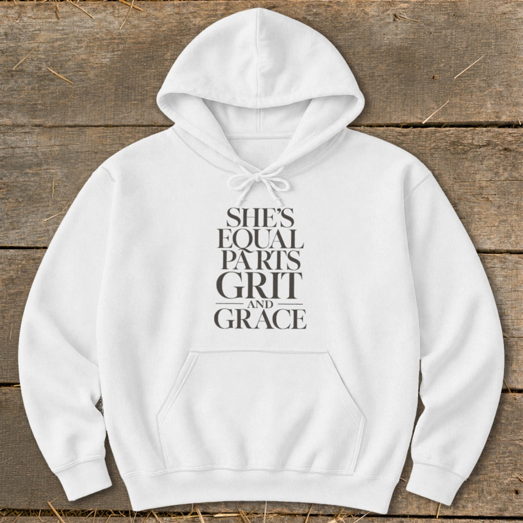 White hoodie with "She's equal parts grit and grace" text design.