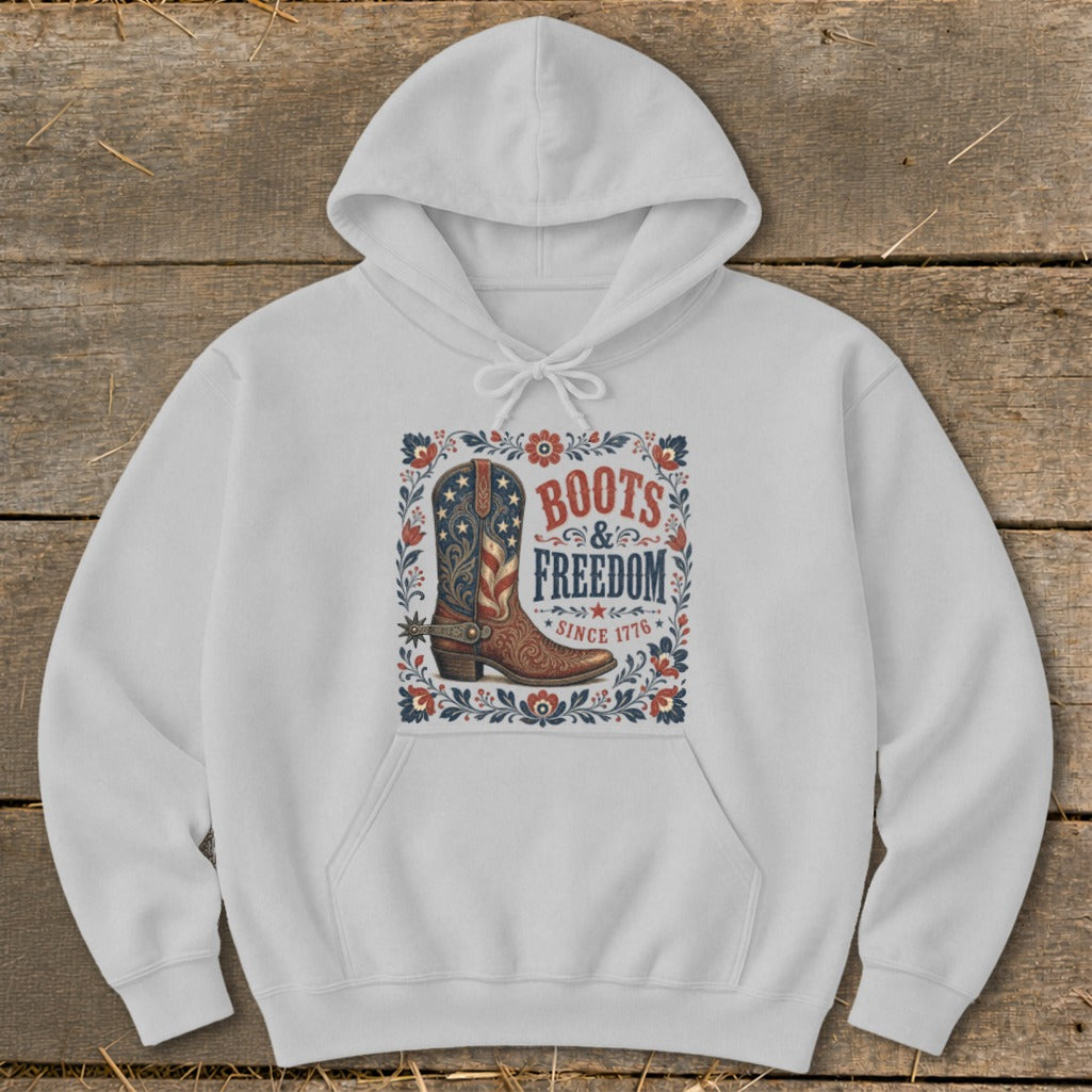 White hoodie with "Boots & Freedom Since 1776" graphic featuring a cowboy boot.