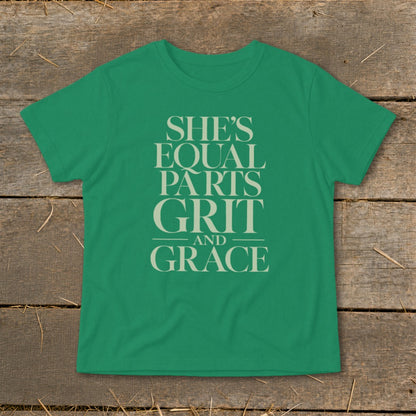 Green t-shirt with cream text reading "She's Equal Parts Grit And Grace".