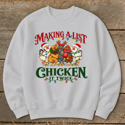 Sweatshirt with chickens wearing Santa hats and Christmas lights, text "Making a list, chicken it twice".
