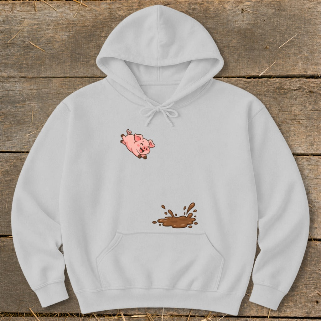 White hoodie with a pink cartoon pig jumping in mud graphic.