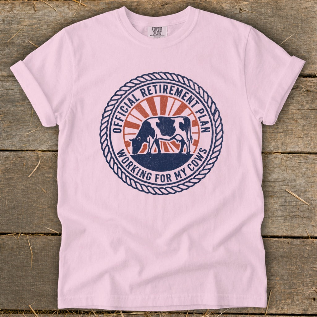 Pink t-shirt with a circular graphic of a cow and text "Official Retirement Plan Working For My Cows".