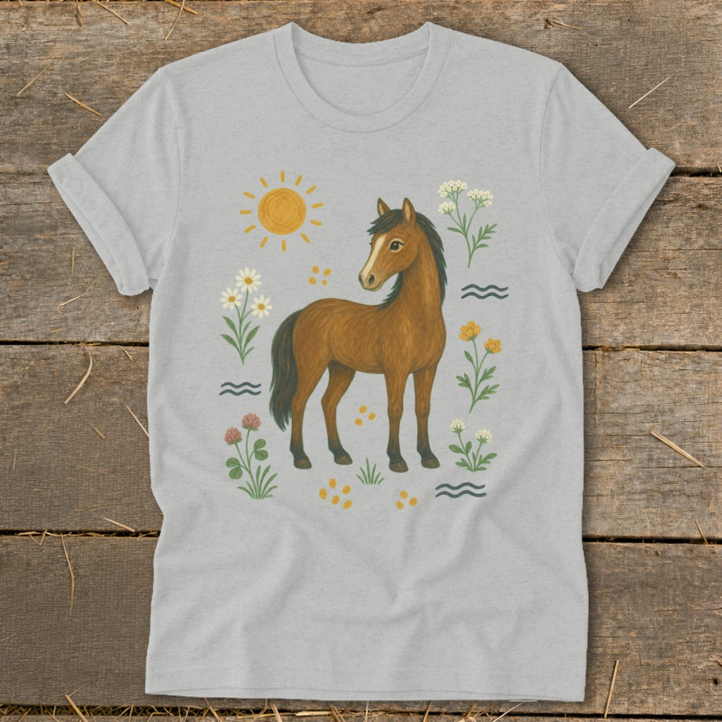 Brown horse with flowers, sun, and waves design on a light grey t-shirt.