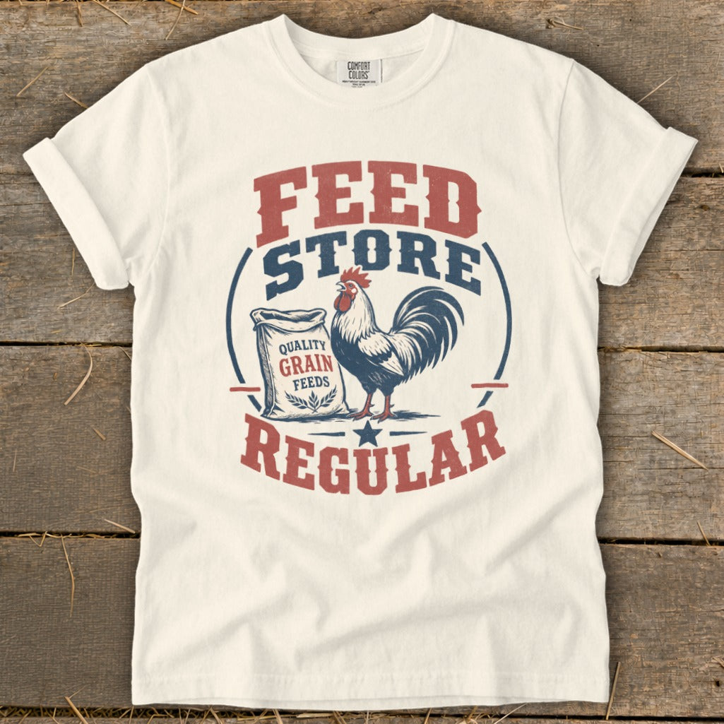 White t-shirt with "FEED STORE REGULAR" text and a rooster by a bag of grain.