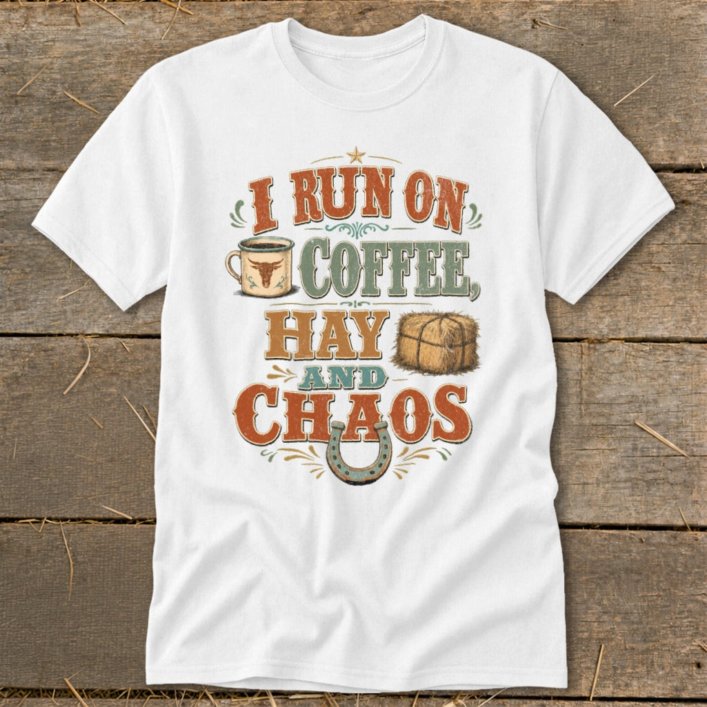 White t-shirt with text "I RUN ON COFFEE, HAY AND CHAOS" featuring a coffee mug, hay bale, and horseshoe.