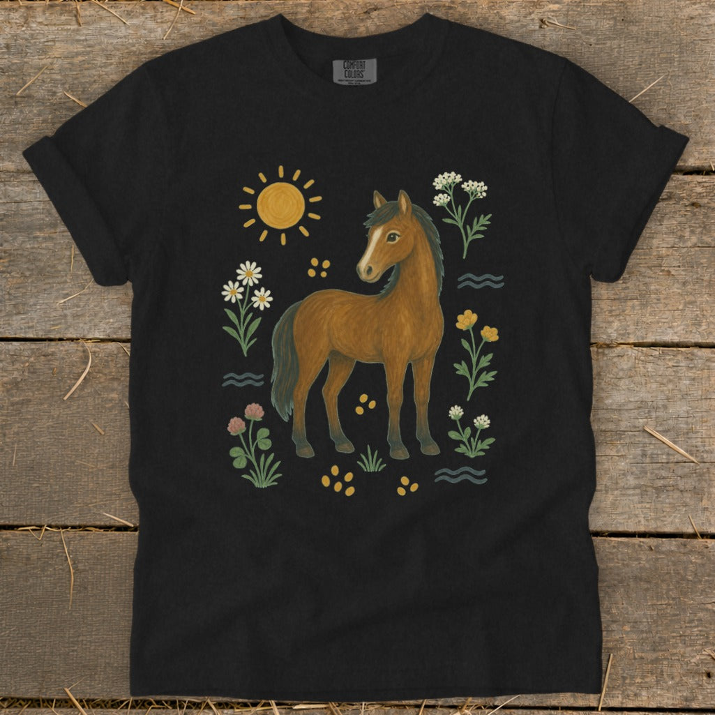 Black t-shirt with a brown horse and floral illustration, including a sun.