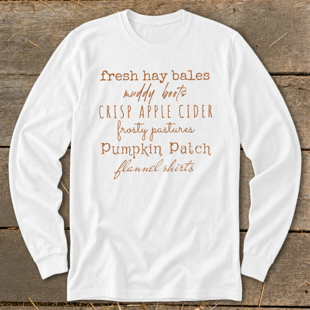 White long-sleeve shirt with text listing fall activities and items.