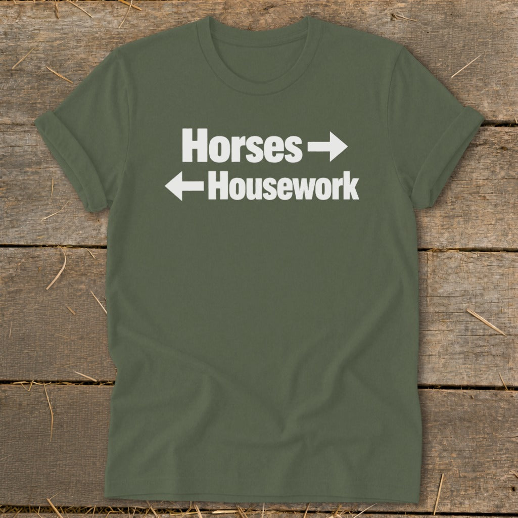 Olive green t-shirt with white text reading "Horses" pointing right and "Housework" pointing left.