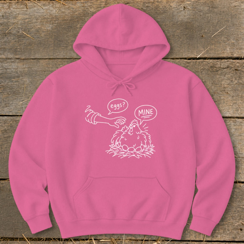 Pink hoodie with white cartoon drawing of a chicken on eggs and a hand saying "eggs? mine".