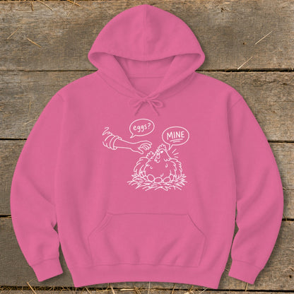 Pink hoodie with white cartoon drawing of a chicken on eggs and a hand saying "eggs? mine".