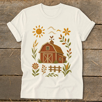 Cream t-shirt with a rustic barn, sun, and floral design.
