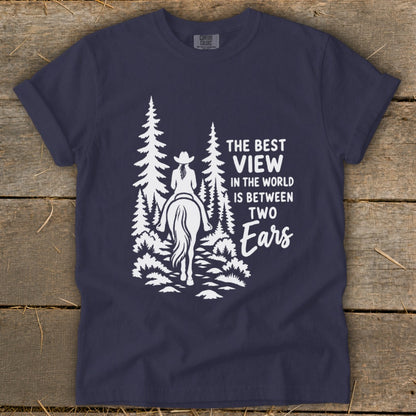 Navy blue t-shirt featuring a white graphic of a horseback rider and text reading The Best View in the World Is Between Two Ears.