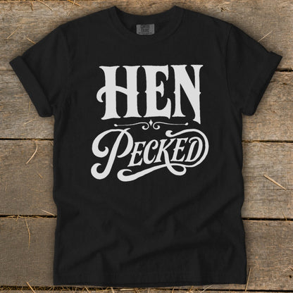 Black t-shirt with white "HEN Pecked" text in vintage lettering.