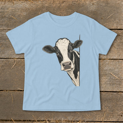 Black and white cow peeking from behind a light blue t-shirt.