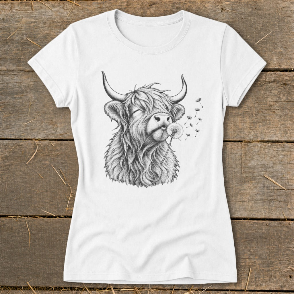 White t-shirt with sketch of a Highland cow blowing a dandelion.