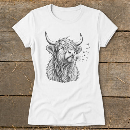 White t-shirt with sketch of a Highland cow blowing a dandelion.