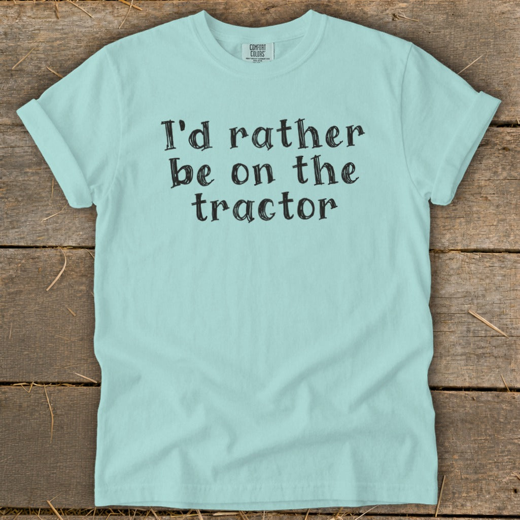 Light blue t-shirt with black text: "I'd rather be on the tractor".