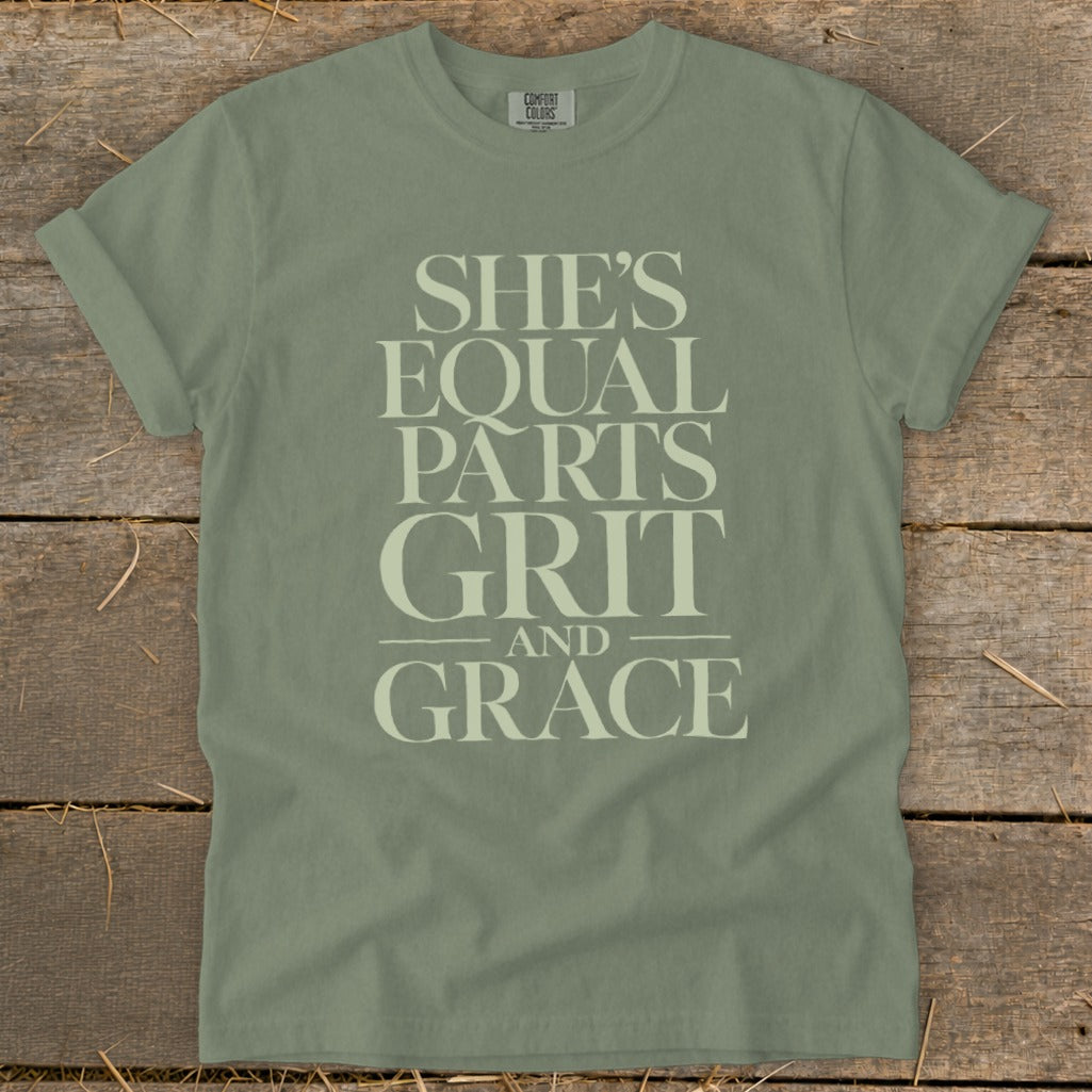Sage green t-shirt with "She's Equal Parts Grit and Grace" graphic text.